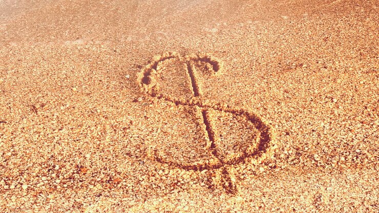 Dollar sign on sand. Sand and currency