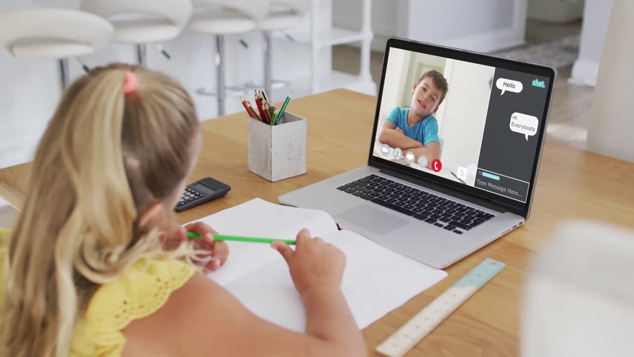 Schoolgirl using laptop for online lesson at home, with boy talking and web chat on screen