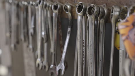 Close-Up-of-Various-Sized-Wrenches-Hanging-Organized-on-a-Workshop-Wall