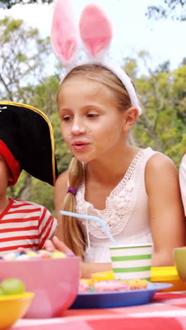 group of kids in various costumes having breakfast