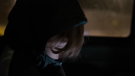 boy traveling by car at cold night