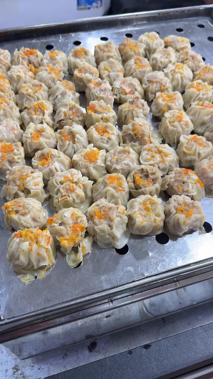 Freshly Steamed Shumai Dumplings on a Metal Tray