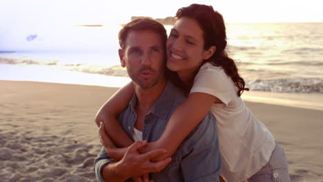 animation of light moving over happy caucasian couple on beach