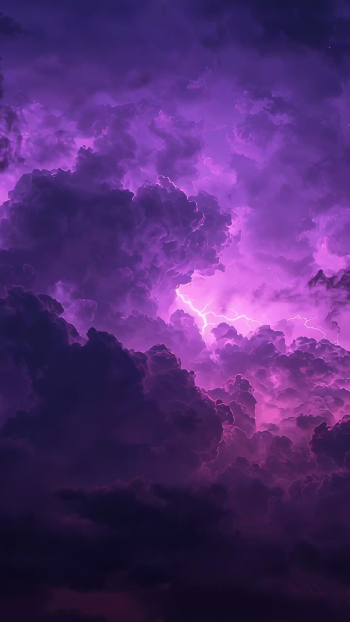 Vertical video: Flashing purple cumulonimbus reacting to internal arc at twilight sending lightning