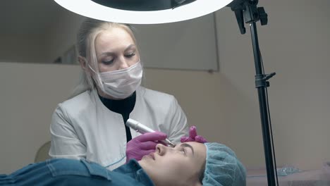 long haired cosmetology specialist colors patient eyebrow