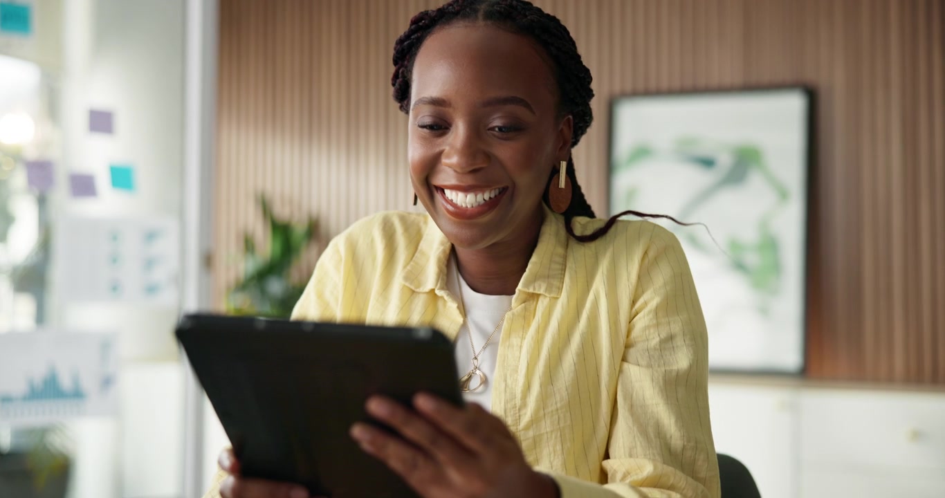 Happy Young Woman Using Tablet in Modern Office