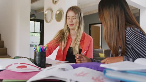 Happy-diverse-teenager-girls-friends-talking-and-learning-together-at-home,-slow-motion