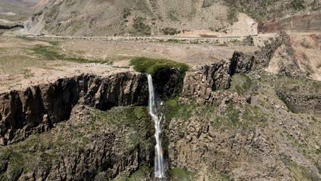 General-aerial-orbit-of-the-inverted-waterfall-located-in-the-Maule-region,-Chile-on-a-sunny-day