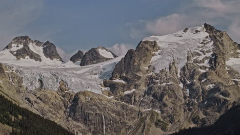 Lower-Joffre-Lake-BC-Canada-Aerial-v2-zoomed-drone-flyover-the-forested-valleys,-capturing-the-mountainous-landscape,-rugged-mountains-and-glacier-capped-peaks---Shot-with-Mavic-3-Pro-Cine---July-2023