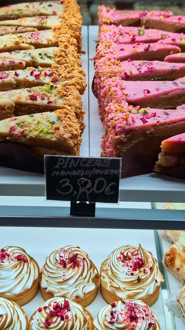 Close-up view of assorted pastries in a bakery display case.