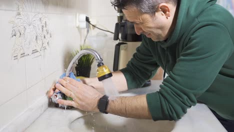Water-gushing-from-a-broken-faucet.-The-landlord-tries-to-fix-it.