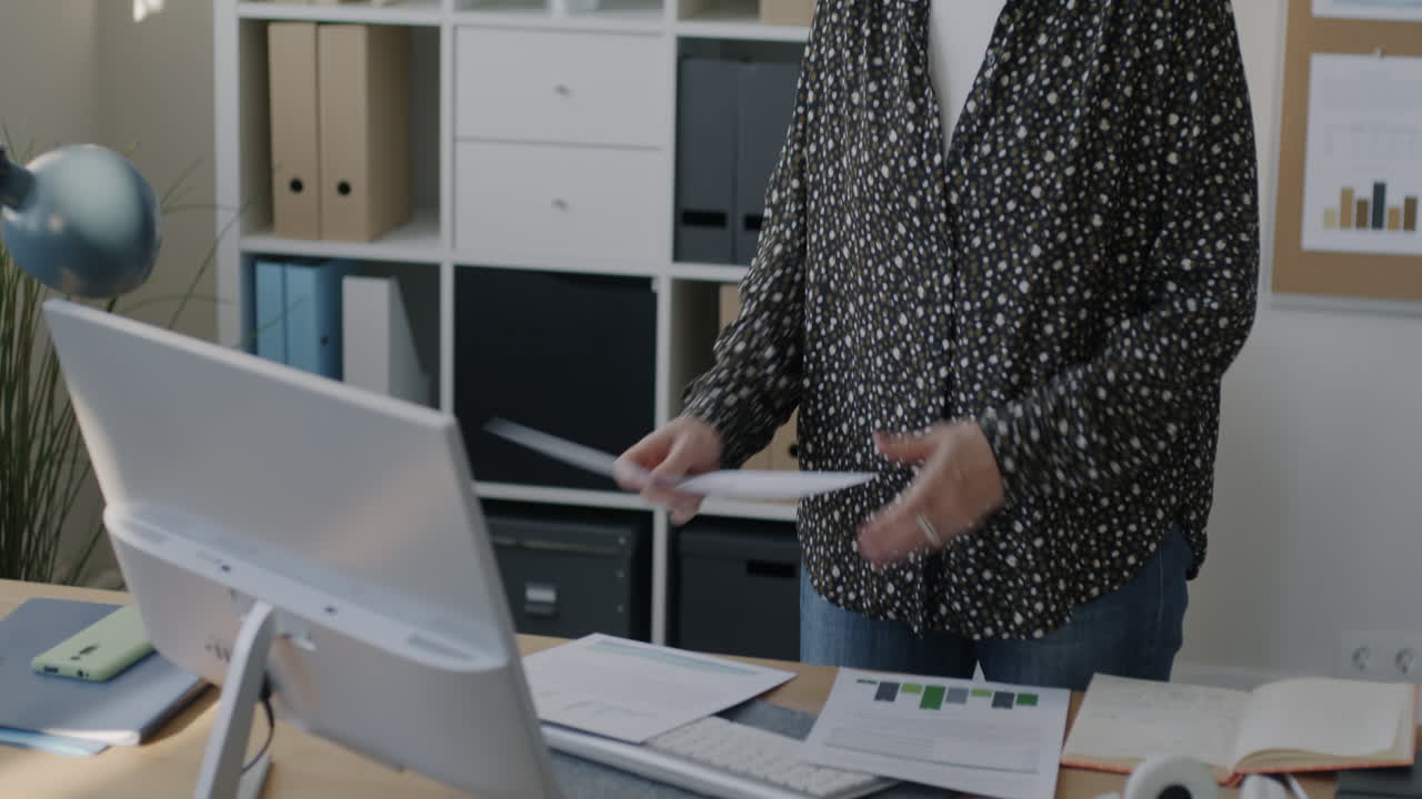 Business Woman Reviewing Reports in Office