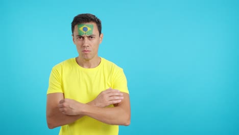 dignified and serious man with brazilian flag painted on face