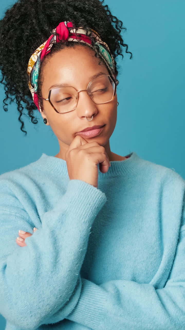 Thoughtful Young Woman Pondering and Looking Around in Studio
