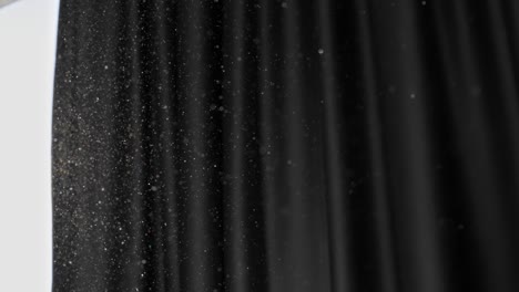 Slow motion shot of floating dust particles in the air. Dust in the room with dark background. Air pollution, allergy, difficulty breathing concept. UHD, high quality