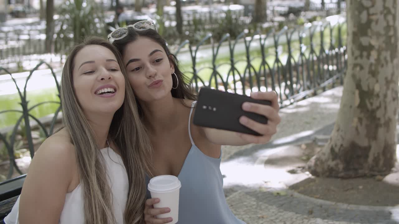 mujer joven feliz posando y tomando selfie