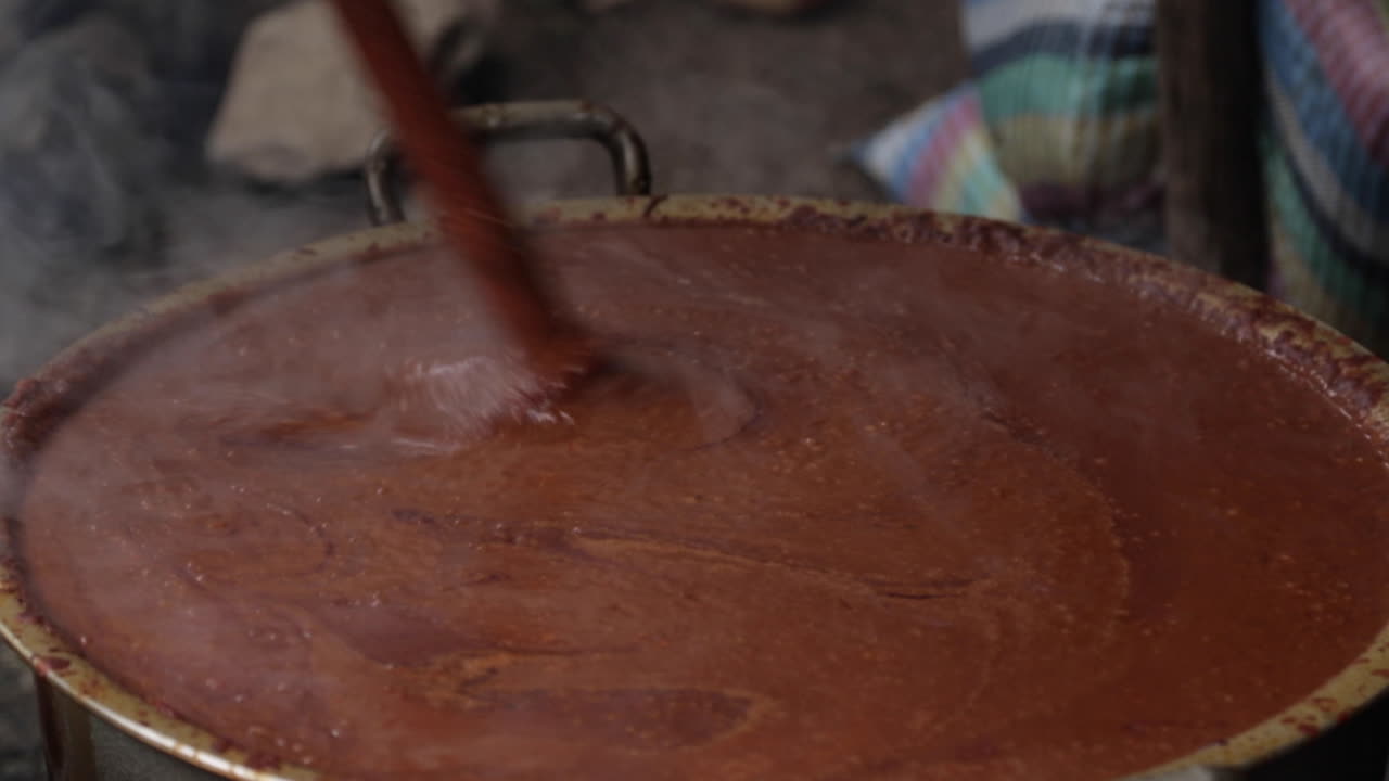 African Woman Stirring Big Pot of Boiling Food for Injera Outside, Sega Wat
