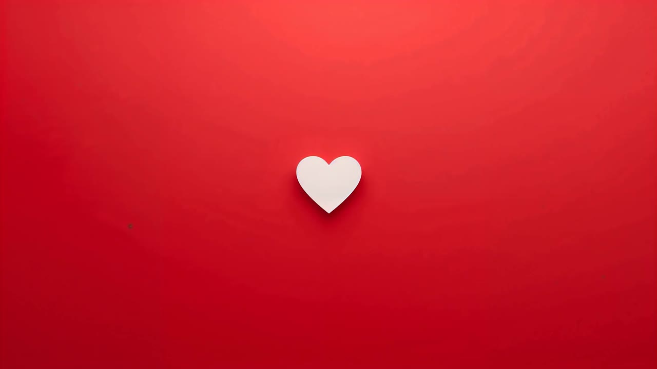 Sequenza iniziale, cuore bianco che si espande e aumenta l'ombra sullo sfondo rosso, diventando prominente