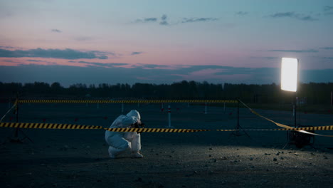 photographer in hazmat suit at night