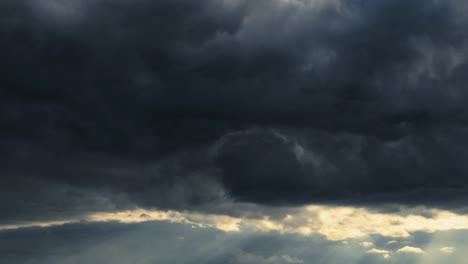 dramatic sunset sky time lapse, bright sunlight and dark silhouette of clouds as a background, extreme weather