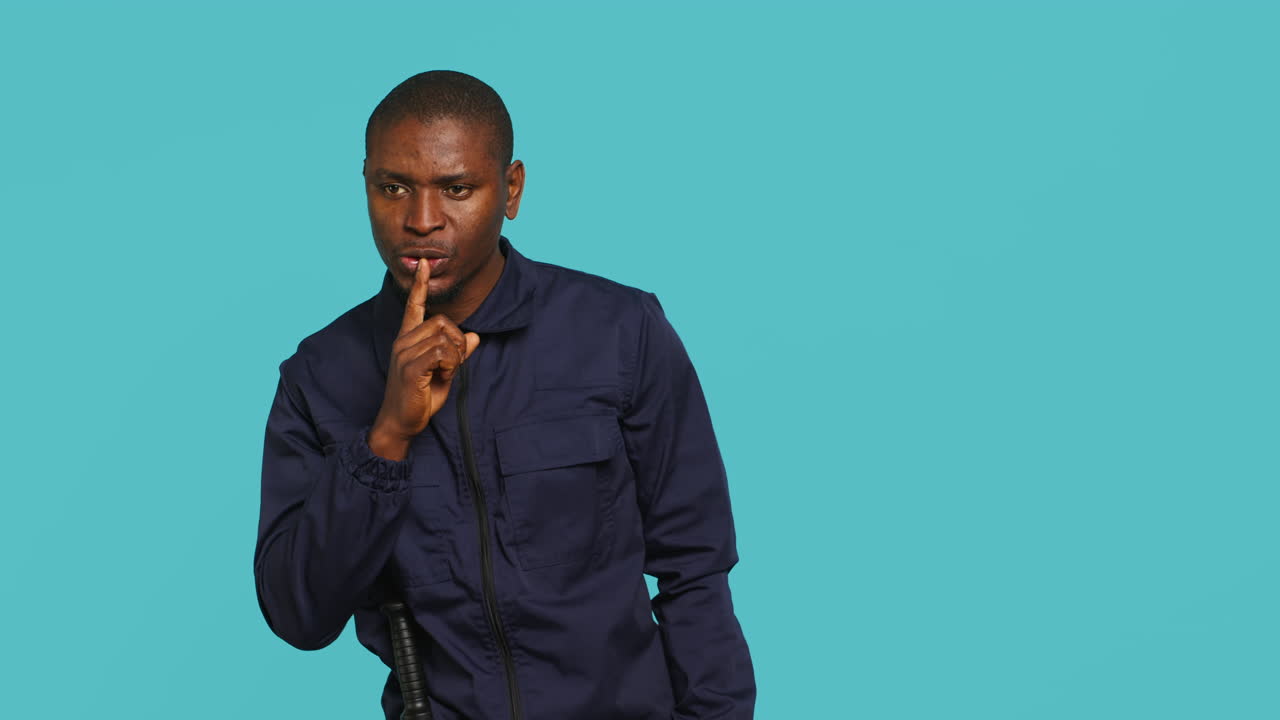 Portrait of stern bodyguard urging people to keep quiet