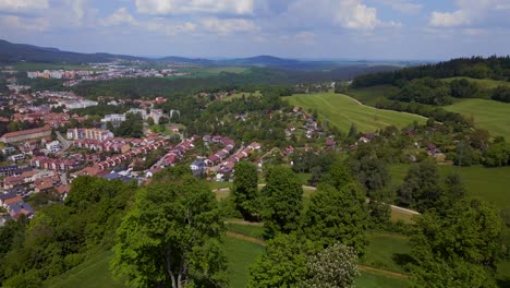 Marvelous-aerial-top-view-flight-big-old-city-Round-Chapel-on-mountain-hill,-Krumlov-Czech-Republic-Summer-2023