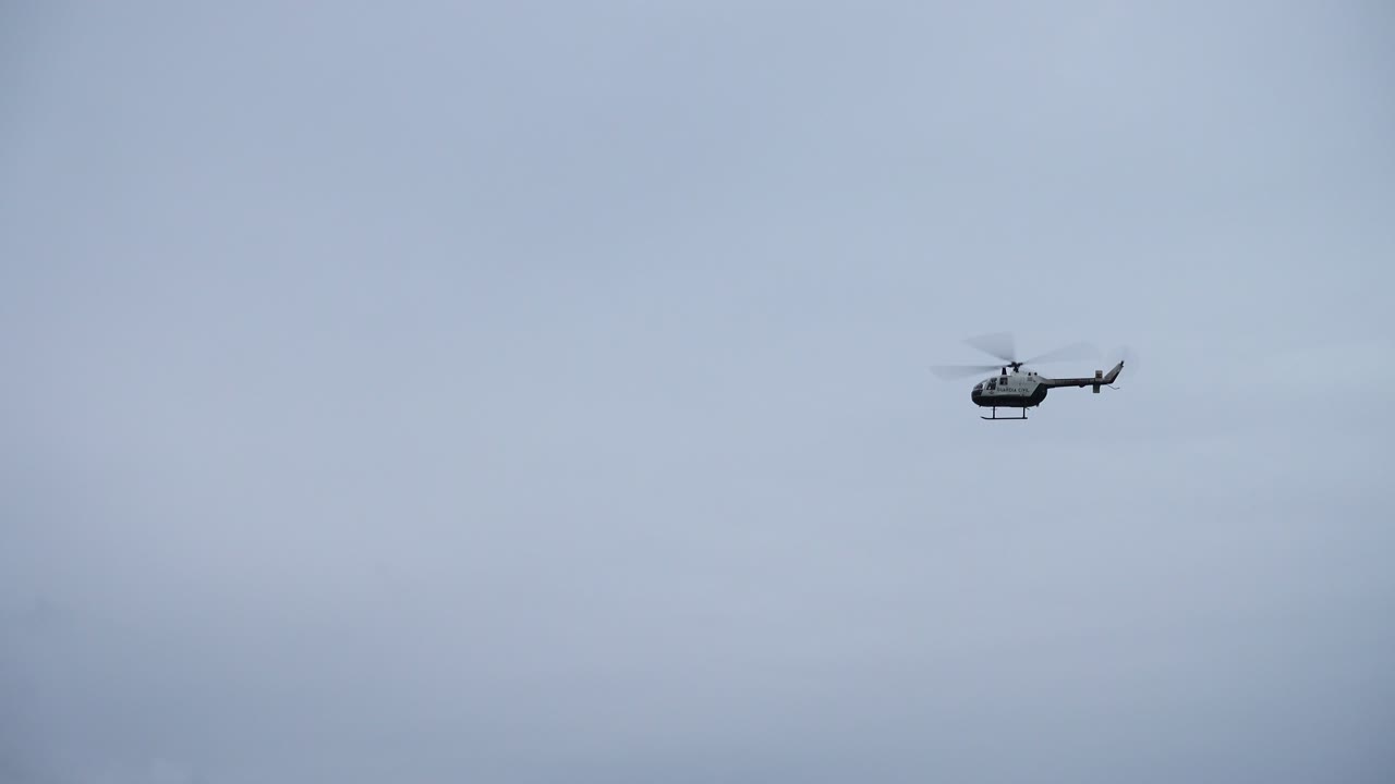 The flying helicopter over the Atlantic Ocean. The helicopter in the sky