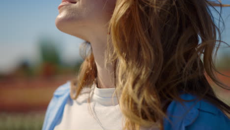 pretty red hair girl with closed eyes dreaming with smile in summer day outside.