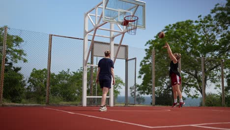 women playing basketball outdoors