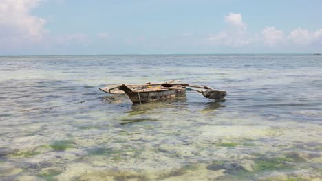 lonesome fishing boat off the coast of paje, zanzibar, tanzania, wide shot