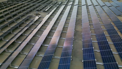 sky reflecting off a large array of solar panels on top of a european hypermarket in helsinki, finland