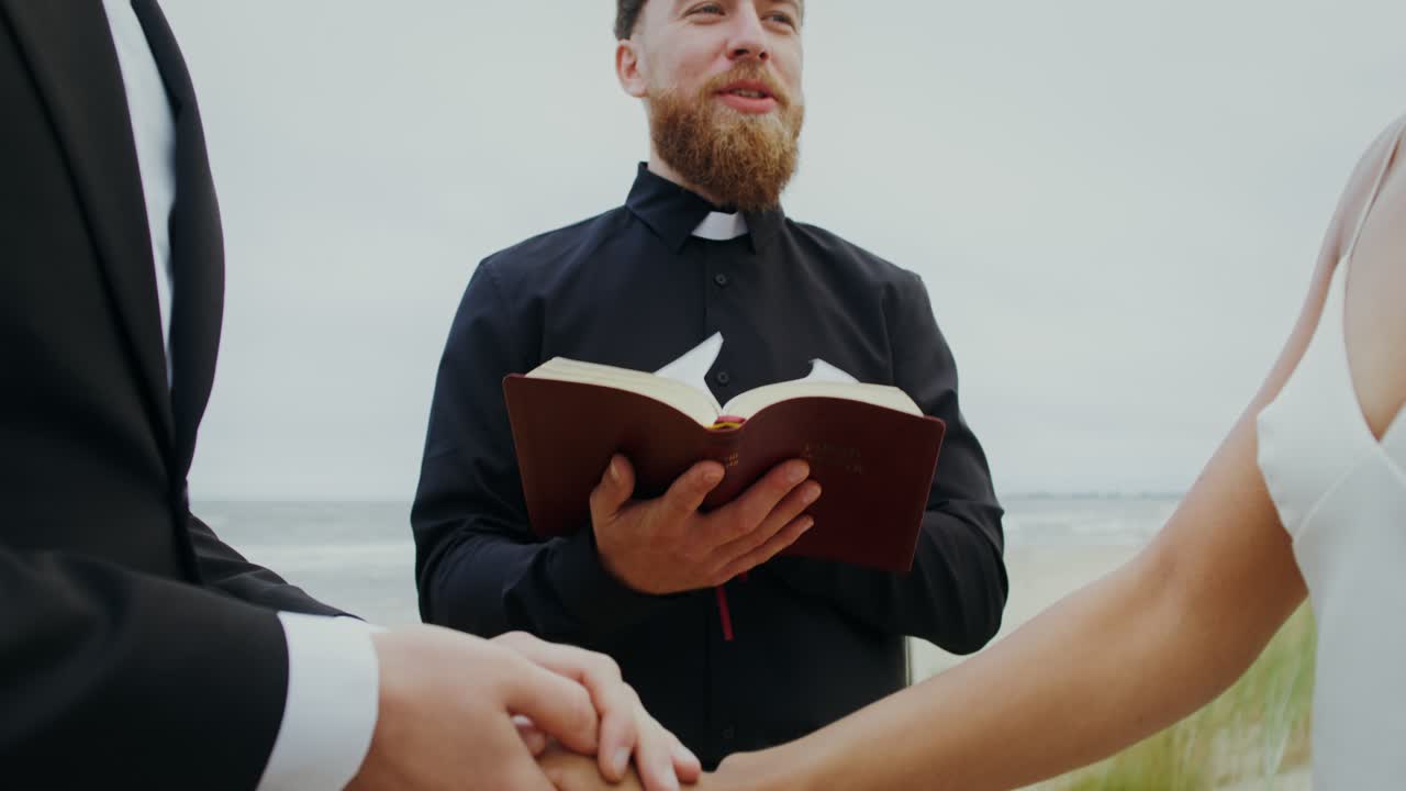 Wedding Ceremony on the Beach with Priest and Bible