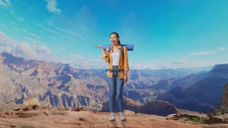 full body of asian female hiker with mountaineering backpack smiling and pointing to side while traveling at the top of mountain