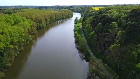 Mayenne-River-crossing-french-countryside,-France.-Aerial-forward