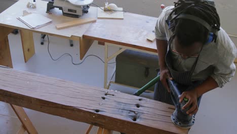 carpenter polishing wood with machine 4k
