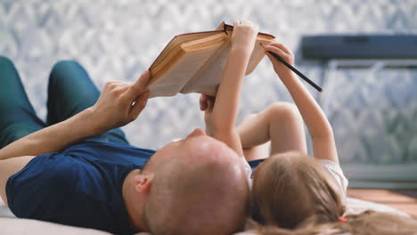 cu, low angle: dad and daughter lie on floor