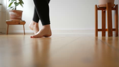 women feet dancing barefoot on wooden floor in apartment