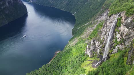 Geirangerfjord-Ferry-and-Waterfall-in-Norway---Scenic-Nature-and-Popular-Tourist-Attraction---Aerial-Circling