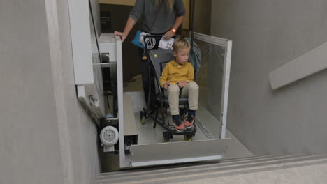 woman and child using lift for carriages