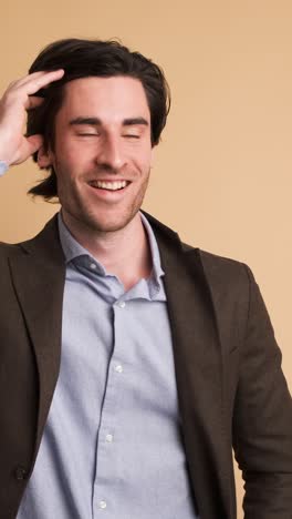 stunned businessman with opened mouth in brown studio