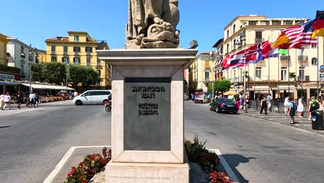 statue amidst traffic and pedestrians in sorrento