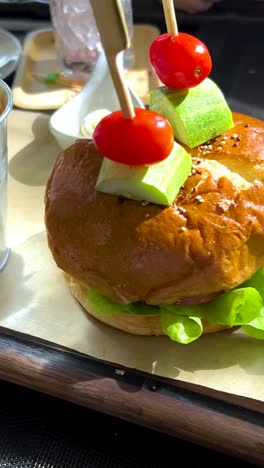 a gourmet burger is served with fries