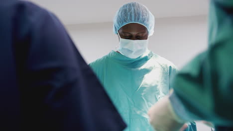 surgical team working on patient in hospital operating theatre