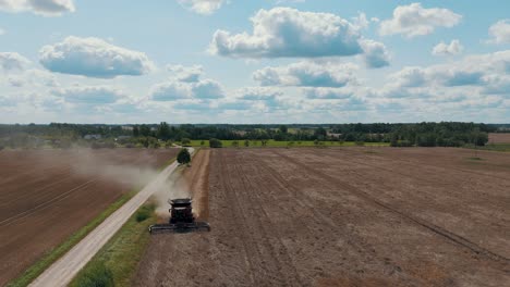 25 august 2024 penkule, latvia - aerial view of combine harvester at work. summer field work on the farm. top view of combine gathering corn or wheat crop.