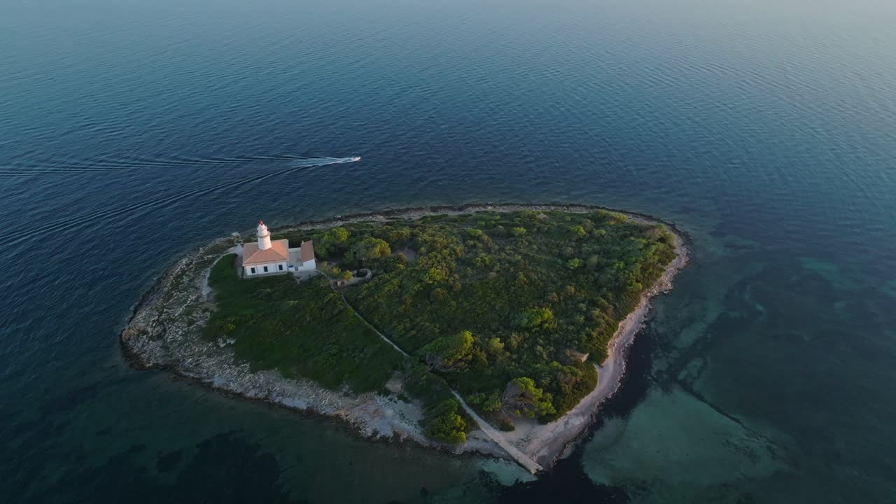 High angle bird's eye view of Alcanada lighthouse as boat drives by in open ocean