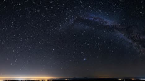 star trails and the milky way over a horizon