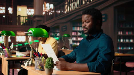 university student researches academic topics in a traditional library