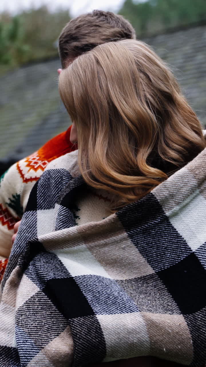 Loving couple in the village. Young man standing close to his girlfriend outdoors. Romantic couple enjoys the time together on nature background. Vertical video