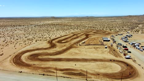 Aerial-view-of-an-off-road-track-during-a-motorcycle-race-in-the-desert---slow-motion