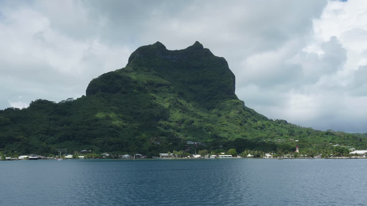 View of a mountain from a moving boat in a tropical pacific island in Bora Bora, French, Polynesia.